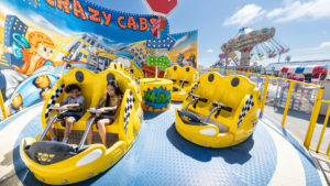 Two children on the Crazy Cabs ride at Jenkinson's Boardwalk